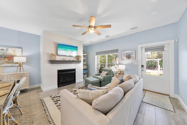 115 N Barcelona Ave, Santa Rosa Beach, FL 32459 - living room with a fireplace, ceiling fan, and wood finished floors