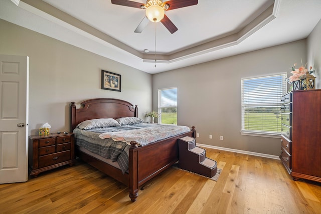 4820 Griffith Rd, Holt, FL 32564 - bedroom featuring light wood-type flooring, a raised ceiling, and ceiling fan