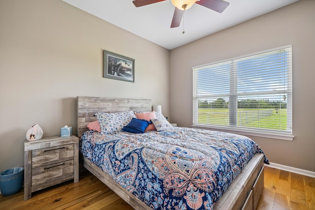 4820 Griffith Rd, Holt, FL 32564 - bedroom with wood finished floors and a ceiling fan