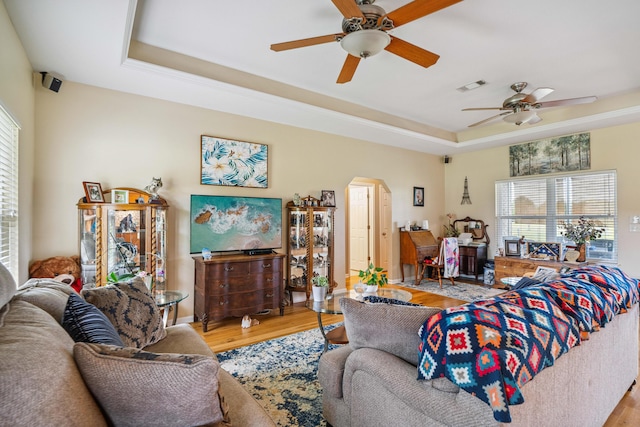 4820 Griffith Rd, Holt, FL 32564 - living area featuring arched walkways, a raised ceiling, wood finished floors, and a ceiling fan