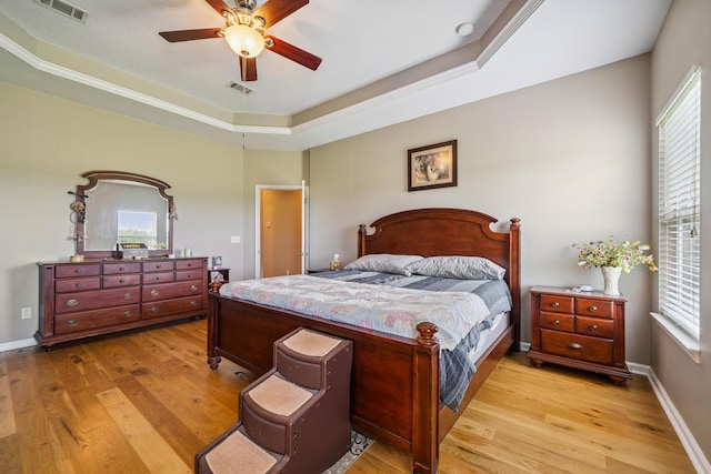 4820 Griffith Rd, Holt, FL 32564 - bedroom featuring light wood-style floors, a raised ceiling, and a ceiling fan