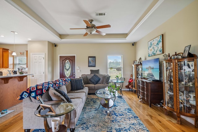4820 Griffith Rd, Holt, FL 32564 - living area with a raised ceiling, ceiling fan, and light wood-style floors