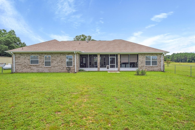 4820 Griffith Rd, Holt, FL 32564 - back of property featuring a sunroom, brick siding, and roof with shingles