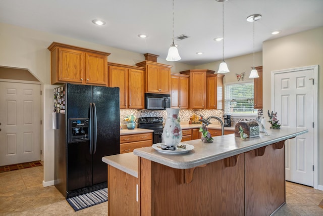 4820 Griffith Rd, Holt, FL 32564 - kitchen with black appliances, decorative backsplash, brown cabinets, a kitchen breakfast bar, and recessed lighting