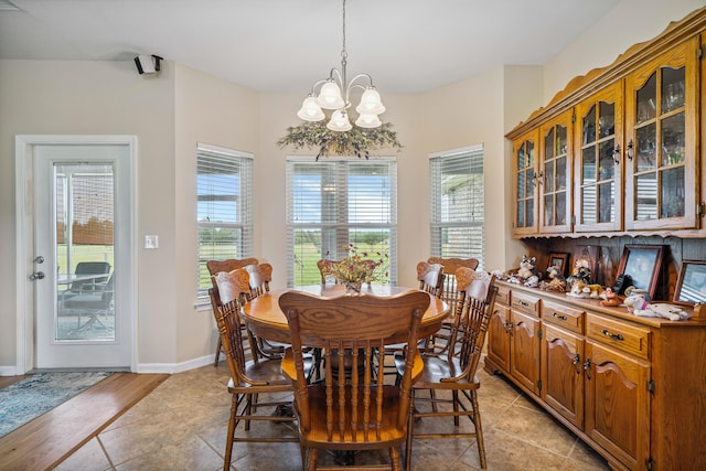 4820 Griffith Rd, Holt, FL 32564 - dining area featuring a chandelier and light tile patterned flooring