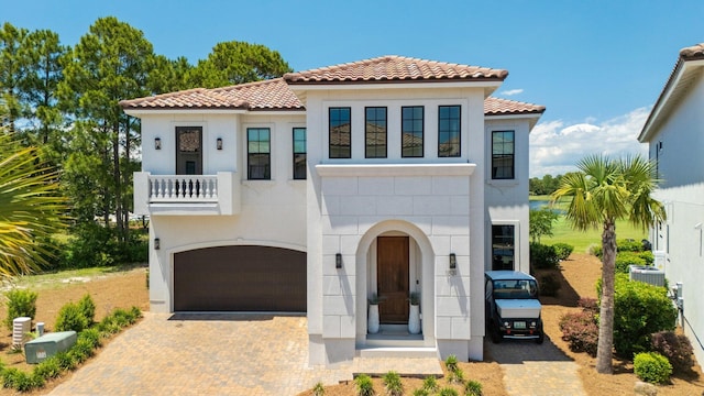 1831 Tuscana Pl, Miramar Beach, FL 32550 - mediterranean / spanish home with a tiled roof, a garage, a balcony, stucco siding, and decorative driveway