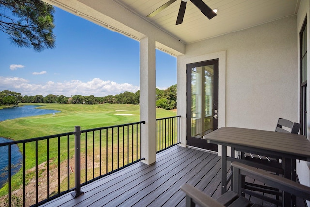 1831 Tuscana Pl, Miramar Beach, FL 32550 - wooden terrace featuring ceiling fan, golf course view, a water view, a lawn, and view of scattered trees