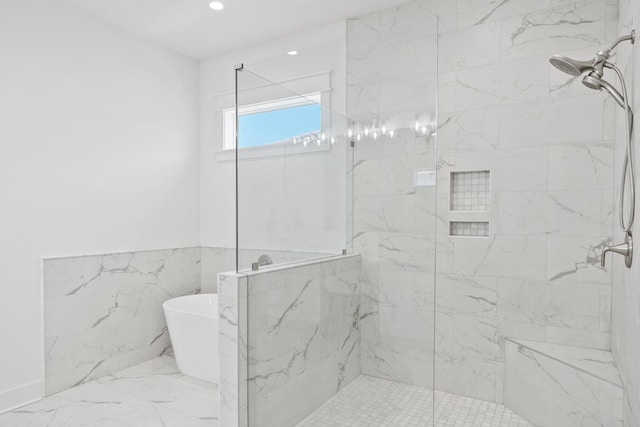 1831 Tuscana Pl, Miramar Beach, FL 32550 - bathroom with a marble finish shower, a freestanding bath, marble finish flooring, wainscoting, and tile walls