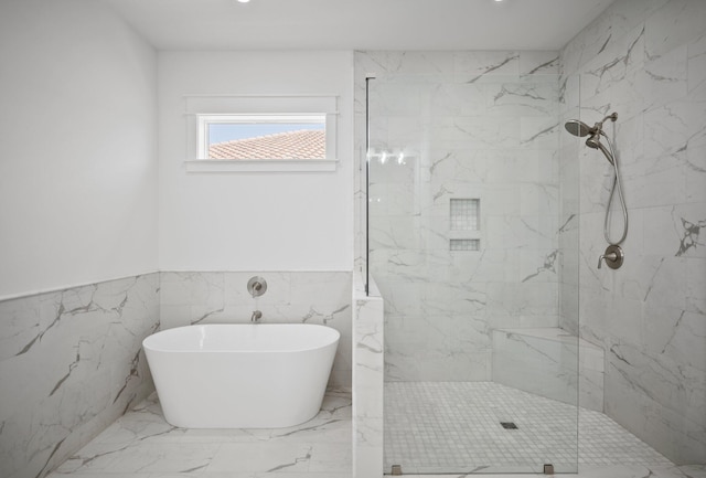 1831 Tuscana Pl, Miramar Beach, FL 32550 - bathroom with a soaking tub, a marble finish shower, marble tiled floors, a wainscoted wall, and tile walls