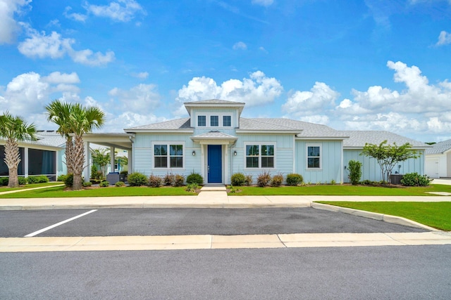 8546 Dreams Float Ct, Panama City Beach, FL 32413 - view of front of house with a front lawn and board and batten siding