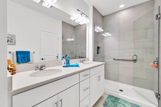 8546 Dreams Float Ct, Panama City Beach, FL 32413 - full bathroom featuring double vanity, a shower stall, and recessed lighting