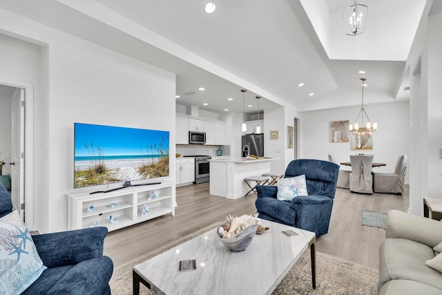 8546 Dreams Float Ct, Panama City Beach, FL 32413 - living room with a chandelier, light wood-style flooring, recessed lighting, and lofted ceiling