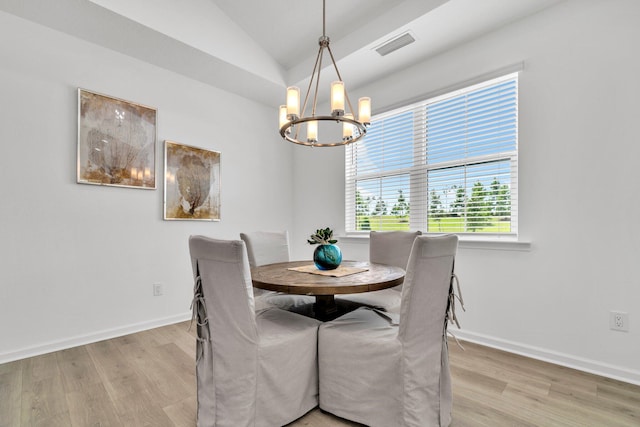 8546 Dreams Float Ct, Panama City Beach, FL 32413 - dining area with a chandelier, light wood-type flooring, and vaulted ceiling