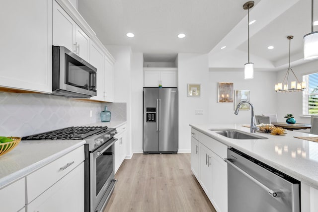 8546 Dreams Float Ct, Panama City Beach, FL 32413 - kitchen with stainless steel appliances, light wood-style flooring, decorative backsplash, white cabinetry, and recessed lighting