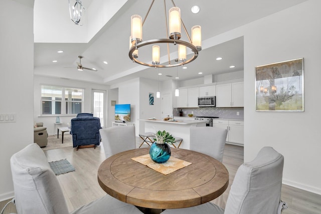 8546 Dreams Float Ct, Panama City Beach, FL 32413 - dining area featuring a chandelier, light wood-type flooring, recessed lighting, a ceiling fan, and vaulted ceiling