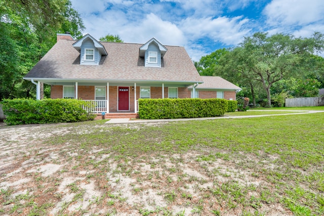 2786 Willow Bend Ct, Crestview, FL 32539 - new england style home with brick siding, a porch, a shingled roof, and a chimney