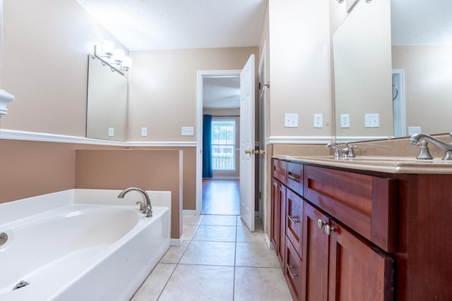 2786 Willow Bend Ct, Crestview, FL 32539 - full bathroom featuring a bath, vanity, tile patterned flooring, and a textured ceiling