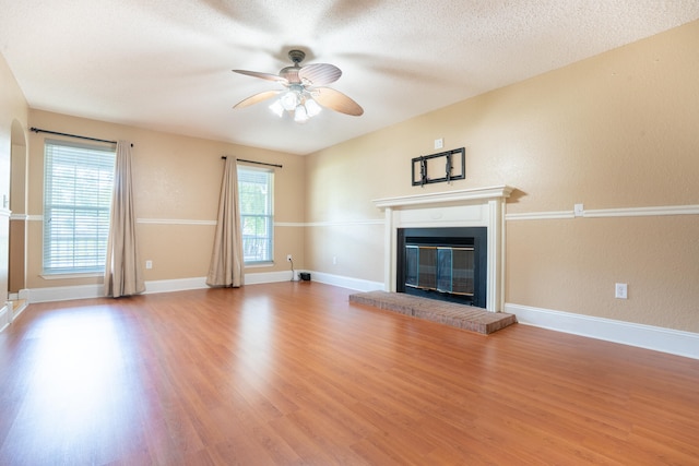 2786 Willow Bend Ct, Crestview, FL 32539 - unfurnished living room featuring a glass covered fireplace, ceiling fan, and wood finished floors