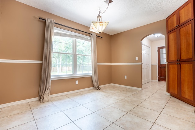 2786 Willow Bend Ct, Crestview, FL 32539 - unfurnished room featuring arched walkways, a textured ceiling, and light tile patterned flooring