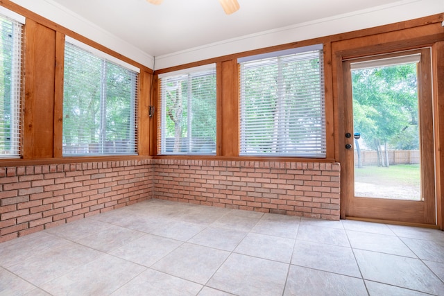 2786 Willow Bend Ct, Crestview, FL 32539 - unfurnished sunroom featuring brick wall, tile patterned flooring, plenty of natural light, and wood walls