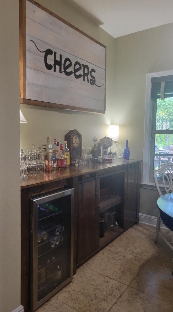 114 S Knightsbridge Ct, Santa Rosa Beach, FL 32459 - indoor dry bar with wine cooler and light tile patterned floors