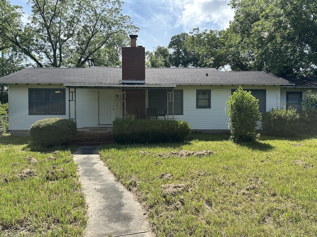 308 S Depot St, Bonifay, FL 32425 - view of front of house featuring a chimney and a front lawn