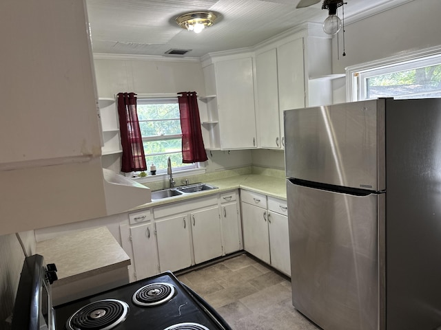 308 S Depot St, Bonifay, FL 32425 - kitchen with freestanding refrigerator, open shelves, light countertops, healthy amount of natural light, and crown molding
