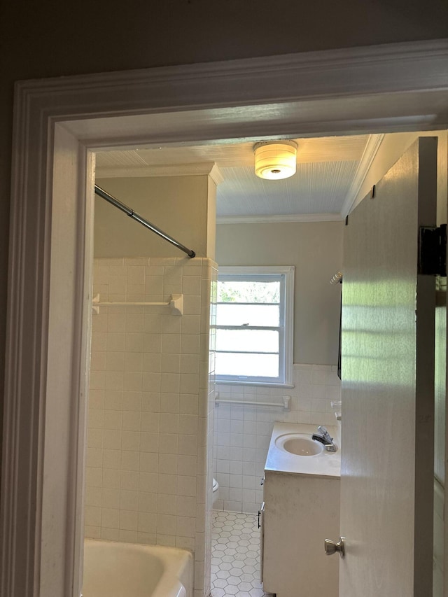 308 S Depot St, Bonifay, FL 32425 - full bath with vanity, tile patterned floors, tile walls, crown molding, and washtub / shower combination