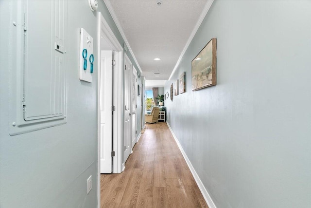 1515 SE Miracle Strip Pkwy Unit 305, Fort Walton Beach, FL 32548 - hallway featuring crown molding, light wood-type flooring, and electric panel