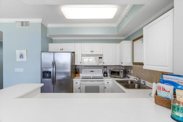 1515 SE Miracle Strip Pkwy Unit 305, Fort Walton Beach, FL 32548 - kitchen with white appliances, tasteful backsplash, light countertops, crown molding, and white cabinetry