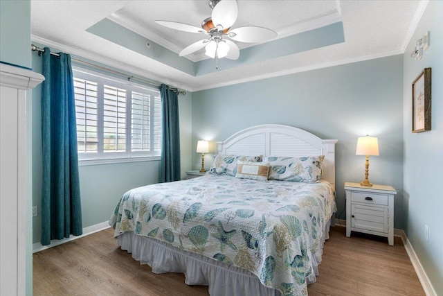 1515 SE Miracle Strip Pkwy Unit 305, Fort Walton Beach, FL 32548 - bedroom with wood finished floors, ornamental molding, a tray ceiling, and ceiling fan