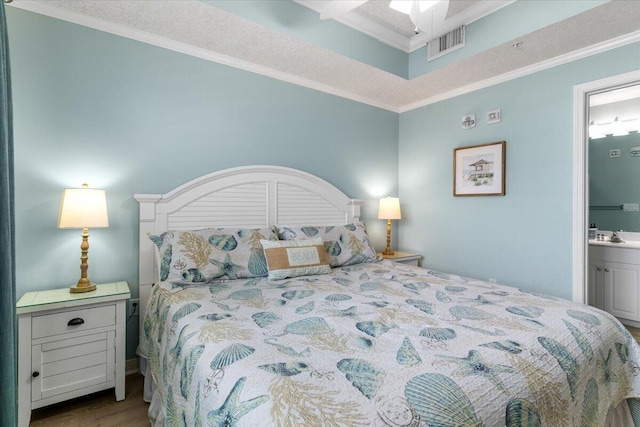 1515 SE Miracle Strip Pkwy Unit 305, Fort Walton Beach, FL 32548 - bedroom with crown molding, ensuite bathroom, and wood finished floors