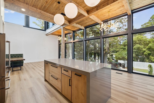 129 Oyster Lake Dr, Santa Rosa Beach, FL 32459 - kitchen with a chandelier, a wooden ceiling with exposed beams, light wood-style floors, a high ceiling, and a center island