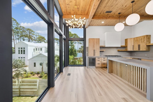 129 Oyster Lake Dr, Santa Rosa Beach, FL 32459 - kitchen featuring wine cooler, a wooden ceiling with exposed beams, light wood finished floors, hanging light fixtures, and light countertops