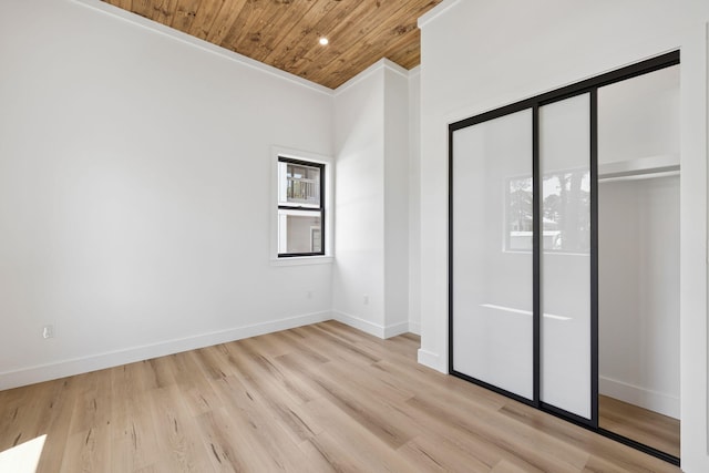 129 Oyster Lake Dr, Santa Rosa Beach, FL 32459 - unfurnished bedroom with wood ceiling, light wood-type flooring, and a closet