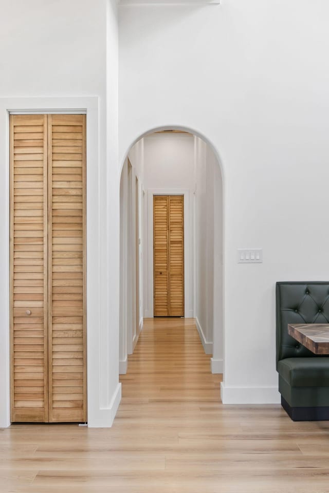 129 Oyster Lake Dr, Santa Rosa Beach, FL 32459 - corridor featuring arched walkways and light wood-style floors