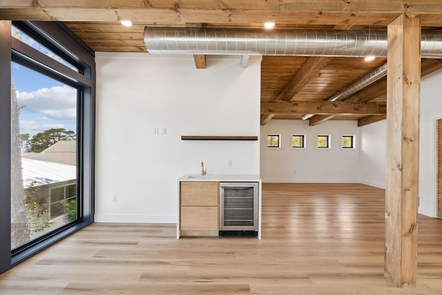 129 Oyster Lake Dr, Santa Rosa Beach, FL 32459 - indoor wet bar featuring wine cooler, healthy amount of natural light, light wood-type flooring, and a wooden ceiling with exposed beams