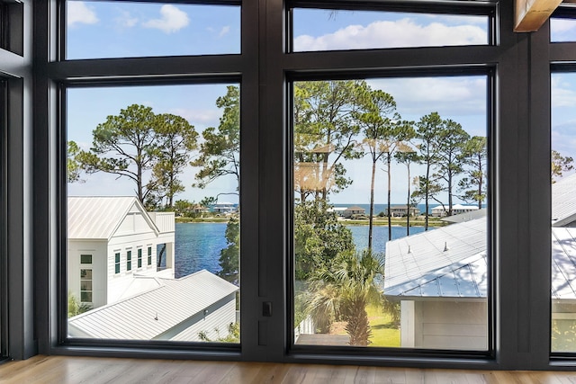 129 Oyster Lake Dr, Santa Rosa Beach, FL 32459 - doorway to outside with a water view, healthy amount of natural light, and wood finished floors