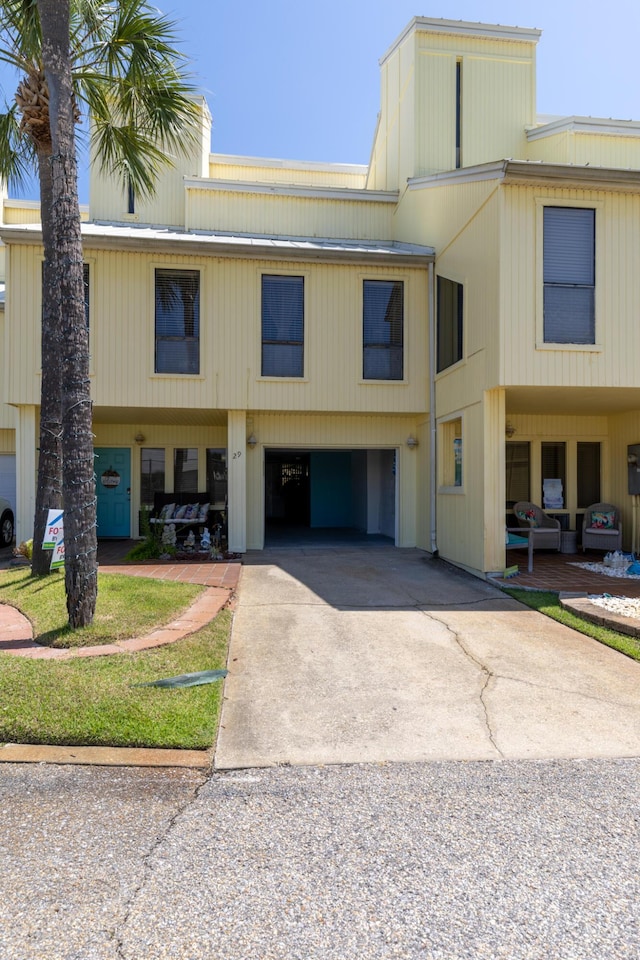 8520 Gulf Blvd Unit 29, Navarre, FL 32566 - view of building exterior featuring concrete driveway and an attached garage