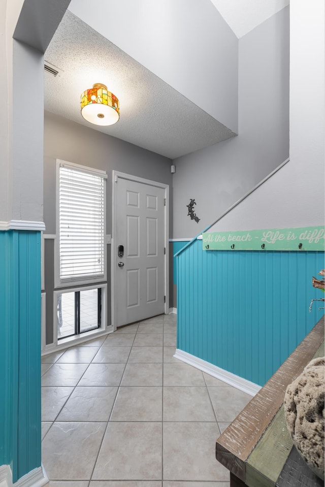 8520 Gulf Blvd Unit 29, Navarre, FL 32566 - entrance foyer featuring a wainscoted wall, a textured ceiling, and tile patterned flooring
