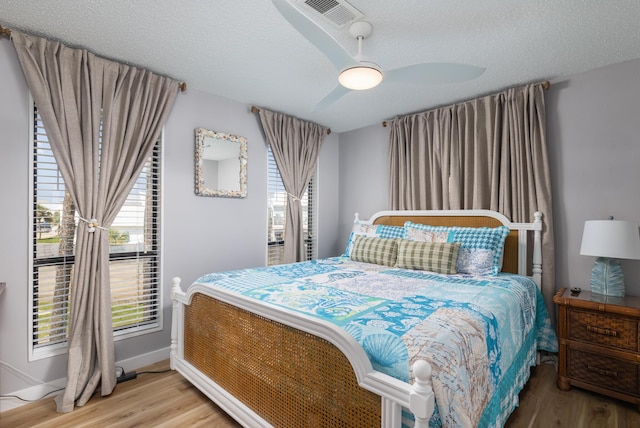 8520 Gulf Blvd Unit 29, Navarre, FL 32566 - bedroom with wood finished floors, a textured ceiling, and ceiling fan