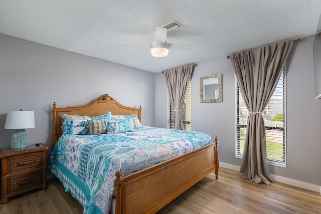 8520 Gulf Blvd Unit 29, Navarre, FL 32566 - bedroom with light wood-type flooring, ceiling fan, and a textured ceiling