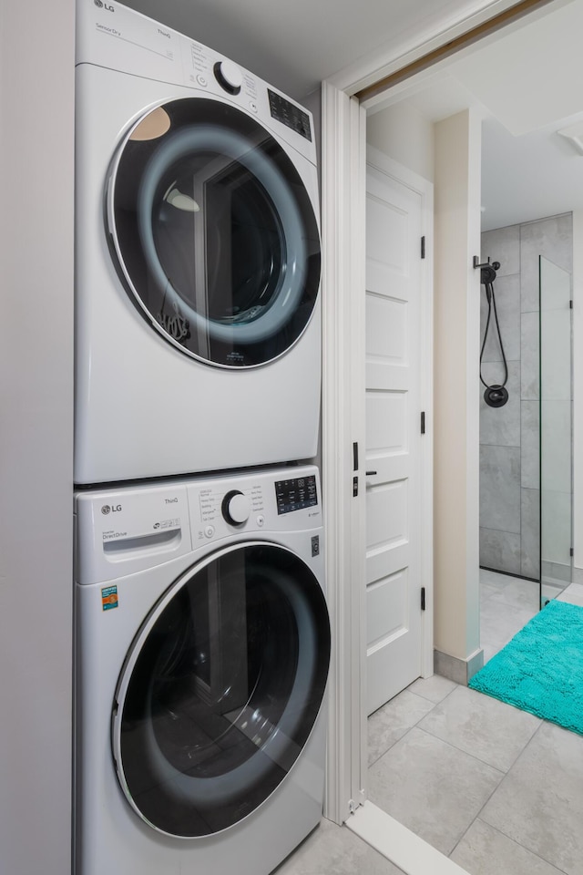 8520 Gulf Blvd Unit 29, Navarre, FL 32566 - laundry room with stacked washer and clothes dryer and light marble finish flooring