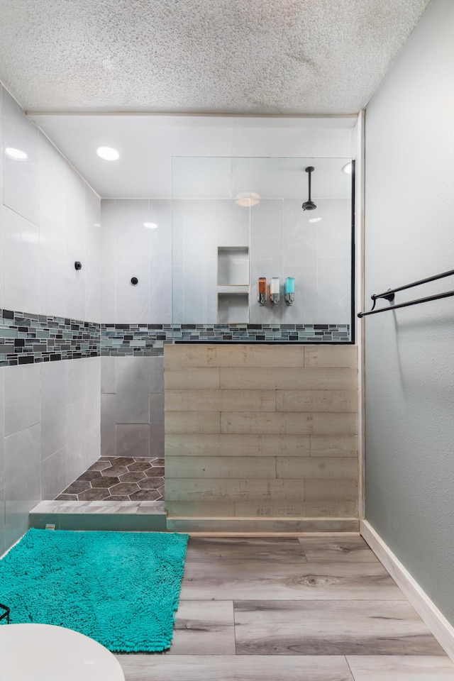 8520 Gulf Blvd Unit 29, Navarre, FL 32566 - full bath with tiled shower, a textured ceiling, and wood finished floors