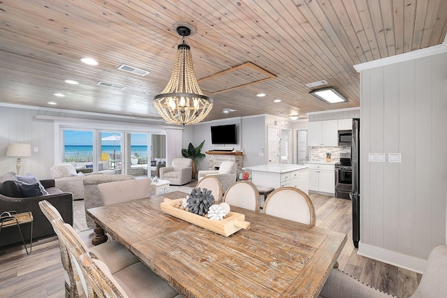 58 Montgomery St, Santa Rosa Beach, FL 32459 - dining room with a chandelier, light wood-style floors, wooden ceiling, ornamental molding, and recessed lighting