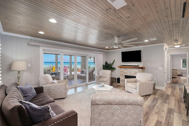 58 Montgomery St, Santa Rosa Beach, FL 32459 - living area with wood ceiling, crown molding, healthy amount of natural light, light wood-style flooring, and a fireplace