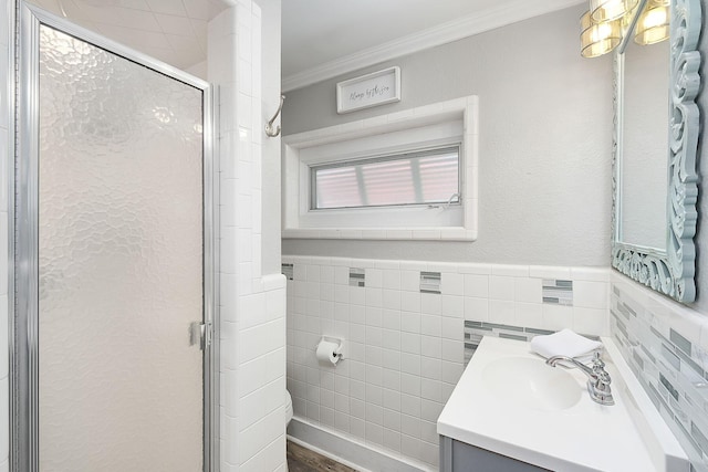 58 Montgomery St, Santa Rosa Beach, FL 32459 - bathroom featuring vanity, ornamental molding, tile walls, a stall shower, and a wainscoted wall