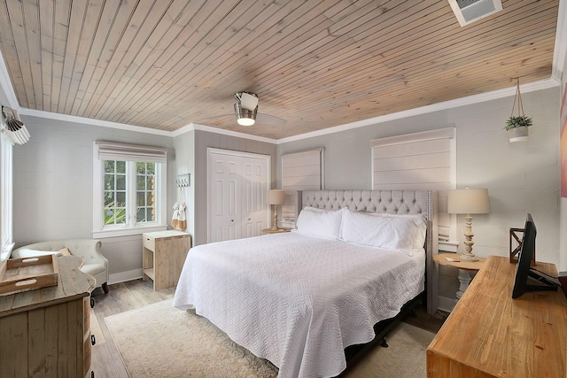 58 Montgomery St, Santa Rosa Beach, FL 32459 - bedroom with wood finished floors, crown molding, wood ceiling, a closet, and ceiling fan