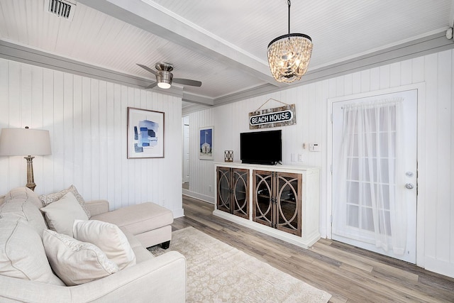 58 Montgomery St, Santa Rosa Beach, FL 32459 - living room featuring a chandelier, wood finished floors, wooden walls, ceiling fan, and ornamental molding