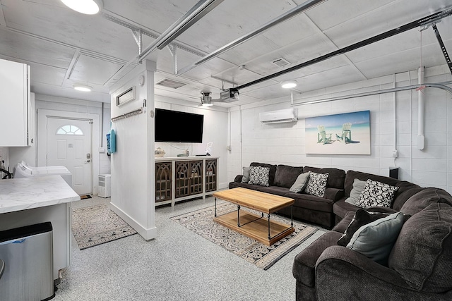 58 Montgomery St, Santa Rosa Beach, FL 32459 - living area featuring an AC wall unit, attic access, and dark aggregate flooring